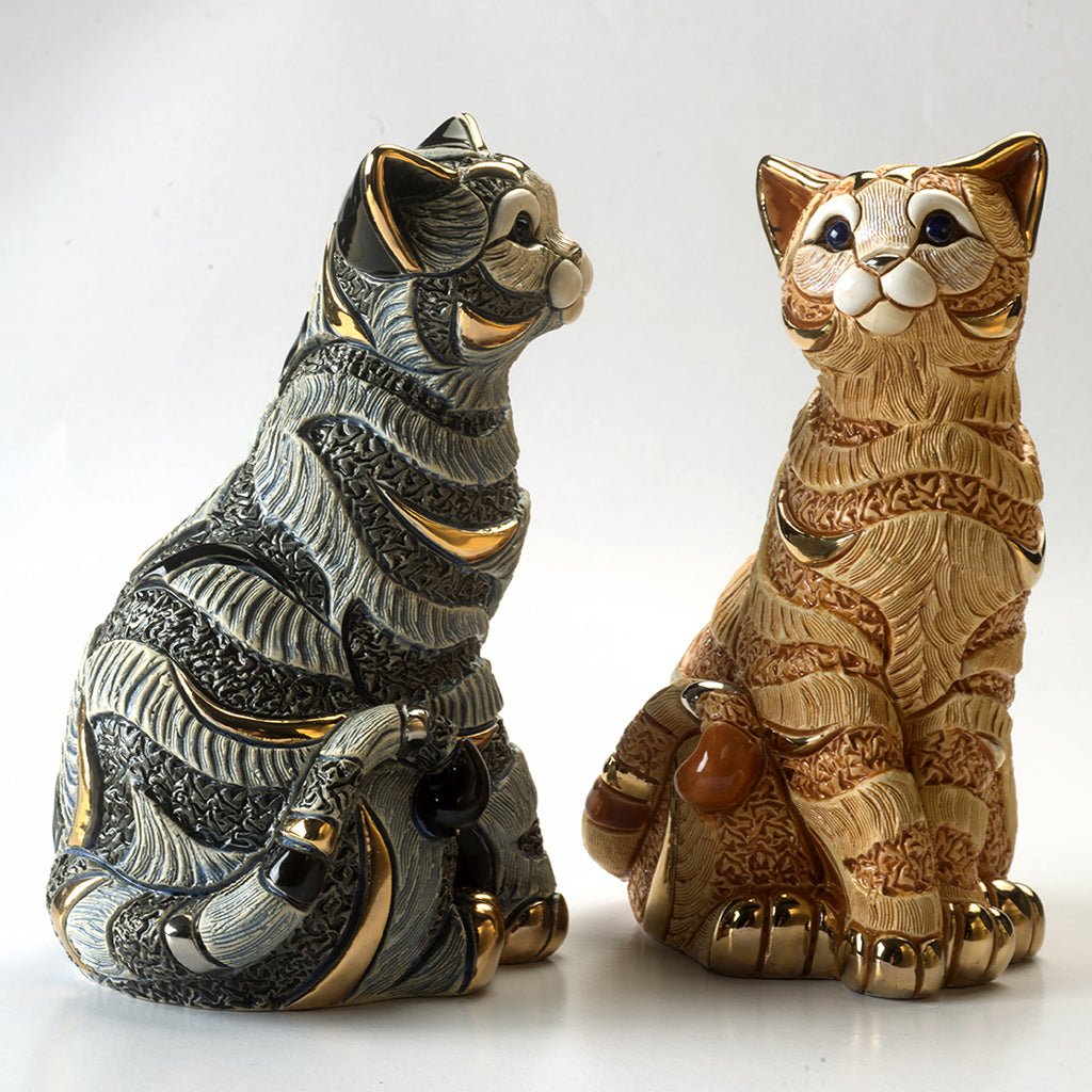 Hand-painted blue and orange tabby cat sculpture with platinum & gold accents. Artisan-crafted Uruguayan collectible figurine symbolizing feline grace and independence.