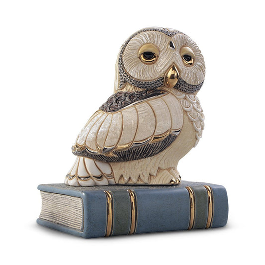 Hand‑carved ivory owl sculpture perched on book with gold accents, artisanal collectible for bookshelf or study décor. Hand‑painted in Uruguay with gold accents. A refined décor piece for scholars, libraries, desks. Scholarly Desk Decor.